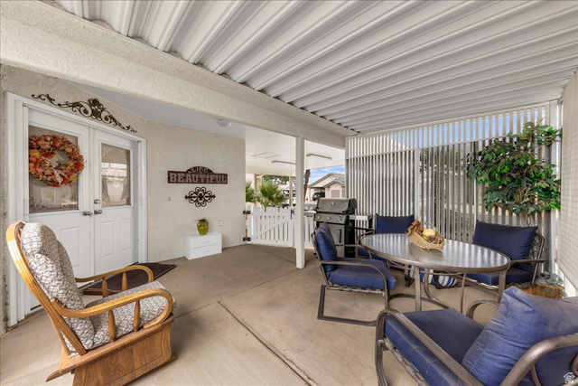 2990 East Riverside Drive, Unit 166 St. George, UT 84790 - Photo 3 of 22 View of patio featuring a gate, outdoor dining space, french doors, and a grill