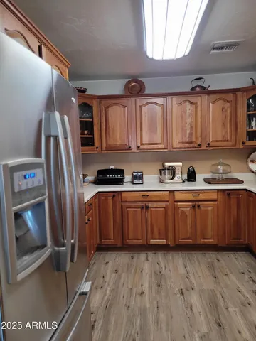 a kitchen with stainless steel appliances granite countertop a sink a stove cabinets and a dining table