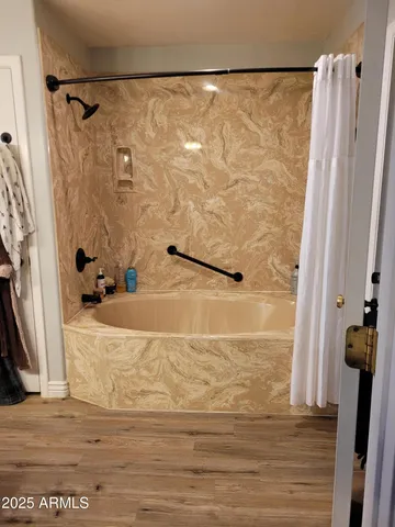 a white toilet sitting next to a shower curtain