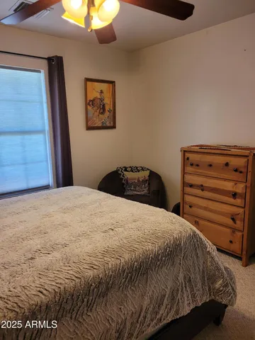 a bedroom with bed and window