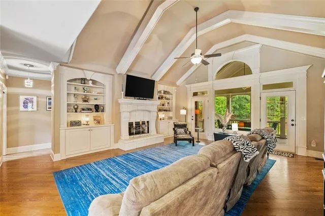 a kitchen with stainless steel appliances a refrigerator a stove a sink dishwasher with a dining table and chairs