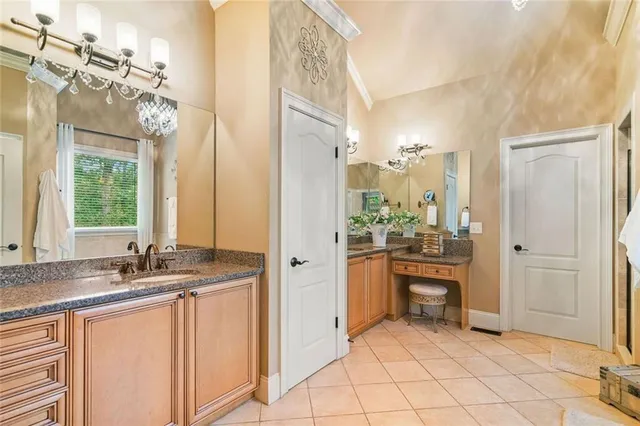 a kitchen with stainless steel appliances kitchen island granite countertop a refrigerator a stove top oven a sink dishwasher and white cabinets with wooden floor