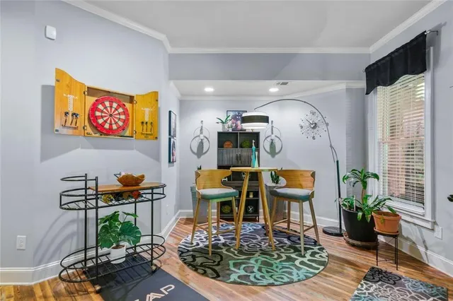 a view of backyard with a table and chairs and a large tree