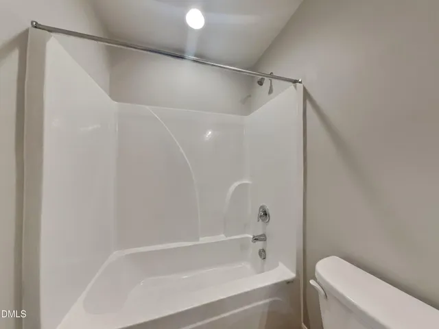 a bathroom with a bathtub and a toilet