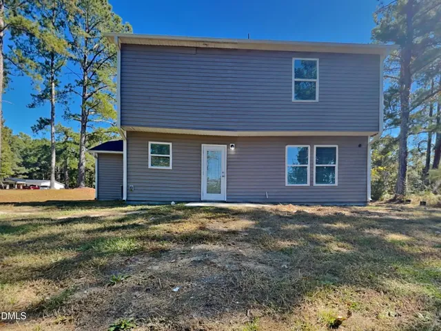 a view of a house with yard and tree s