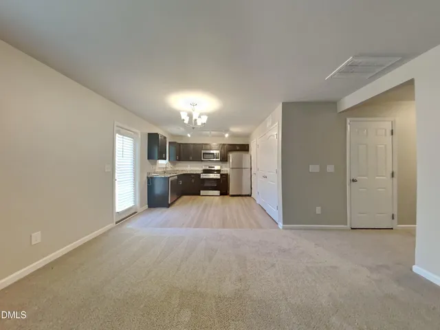 a view of a livingroom with furniture and a chandelier