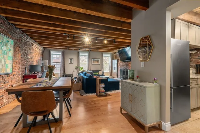 a view of a dining room with furniture and a large window