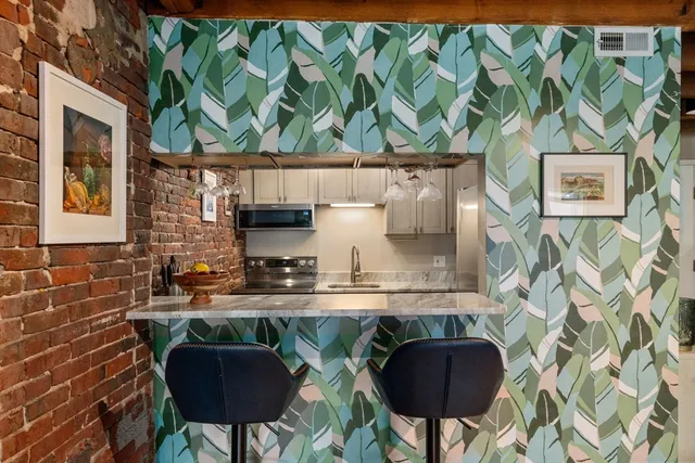 a kitchen with a stove and a chair