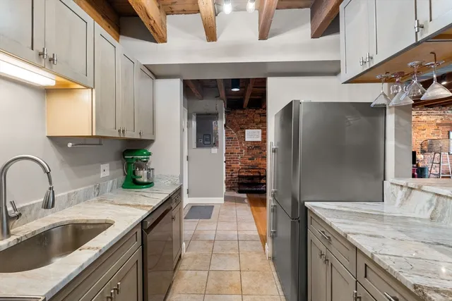 a kitchen with stainless steel appliances granite countertop a sink stove and cabinets