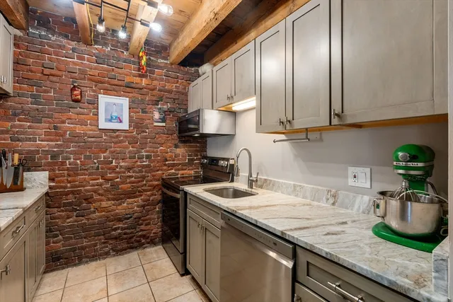 a kitchen with stainless steel appliances granite countertop a sink a stove and cabinets