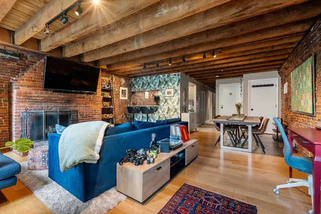 a living room with fireplace furniture and a flat screen tv