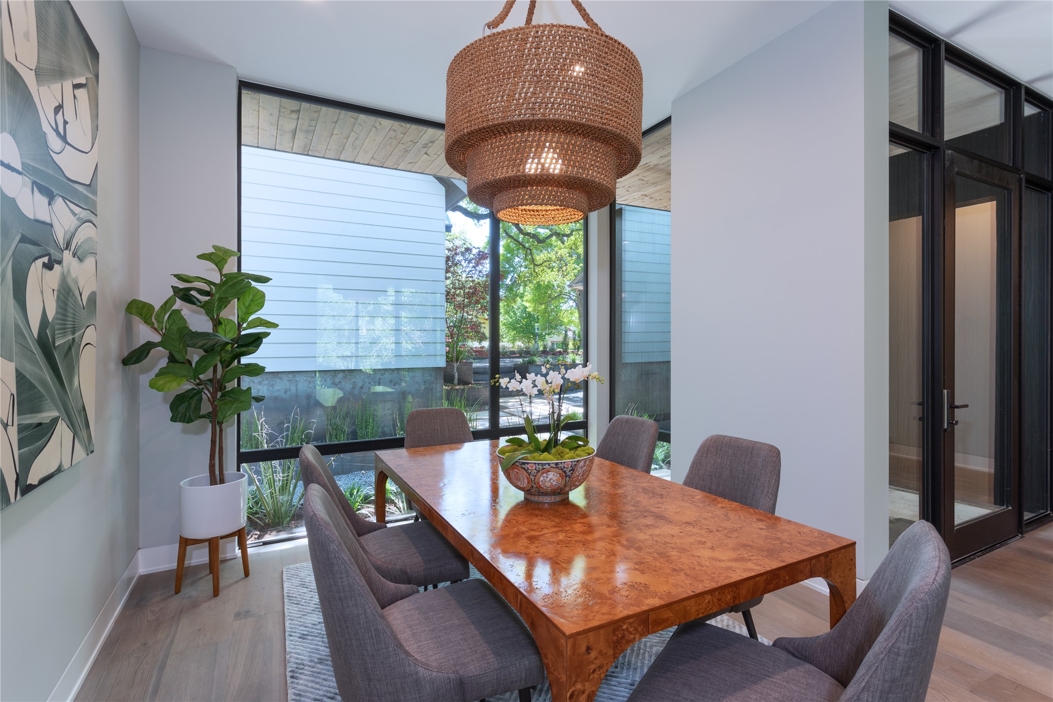 700 Jessie Street Austin, TX 78704 - Photo 11 of 40 Dining area with floor to ceiling windows and wood finished floors