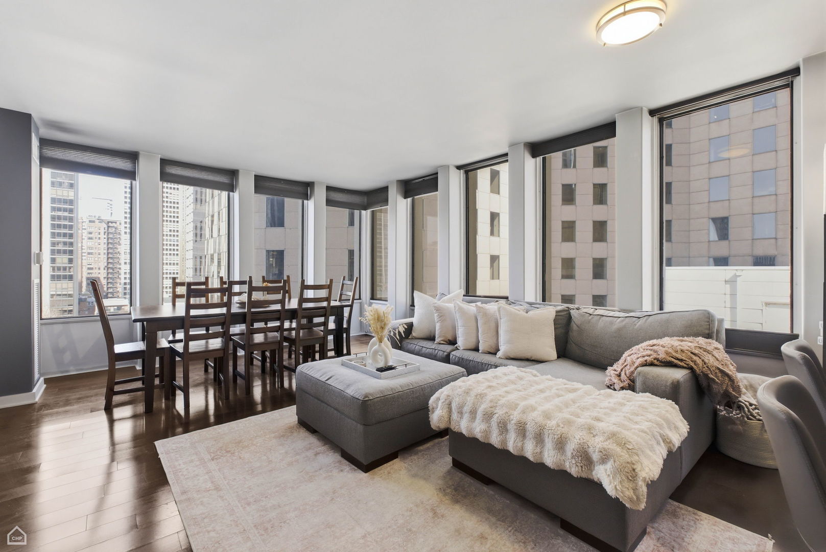 100 East Walton Street, Unit 11B Chicago, IL 60611 - Photo 6 of 13 a living room with furniture and large windows