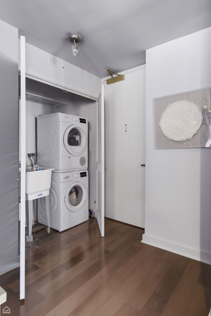 100 East Walton Street, Unit 11B Chicago, IL 60611 - Photo 8 of 13 a view of walk in closet with clothes and shoes