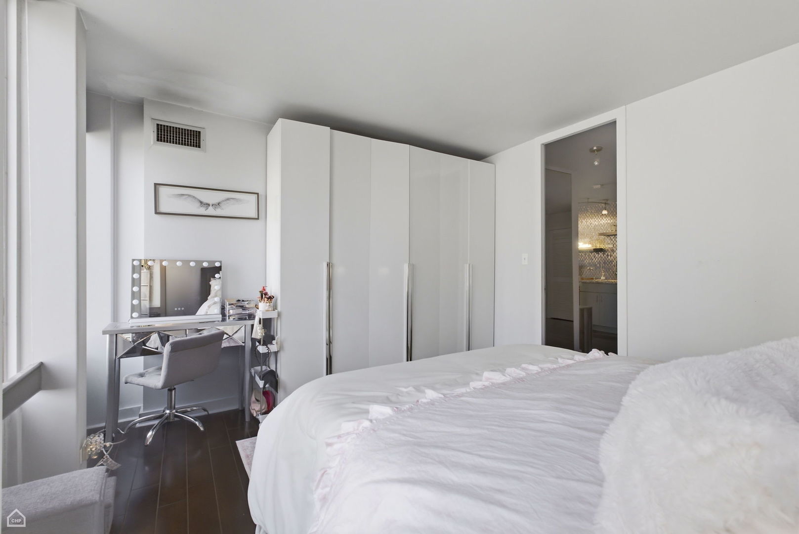 100 East Walton Street, Unit 11B Chicago, IL 60611 - Photo 10 of 13 a bedroom with a bed and a chair