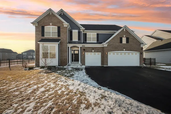 a front view of a house with a yard