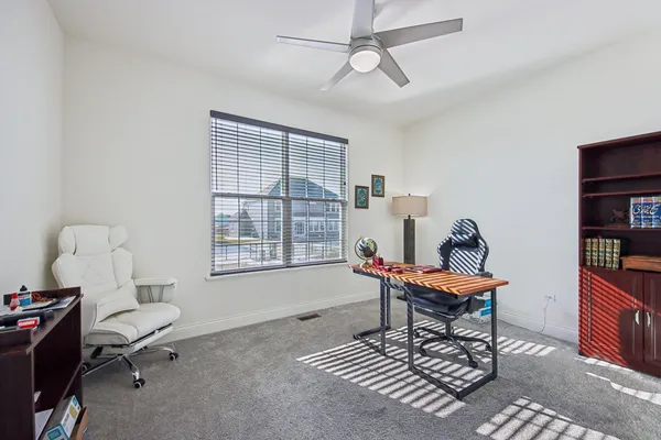 a living room with furniture a rug and a window