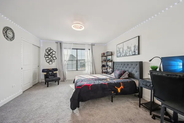 a bedroom with a bed and a table in it