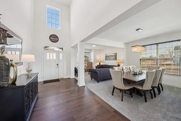 a dining room with furniture and wooden floor