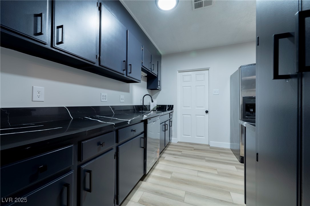 238 Kansas Avenue Henderson, NV 89015 - Photo 16 of 61 Kitchen featuring light wood finished floors and stainless steel appliances