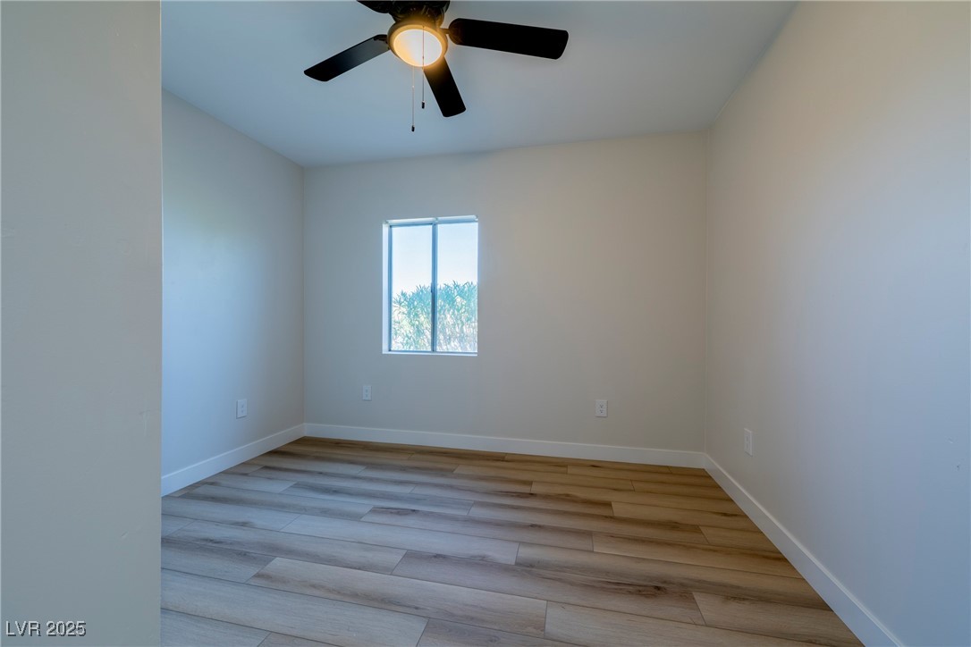 238 Kansas Avenue Henderson, NV 89015 - Photo 17 of 61 Unfurnished room featuring light wood finished floors and a ceiling fan