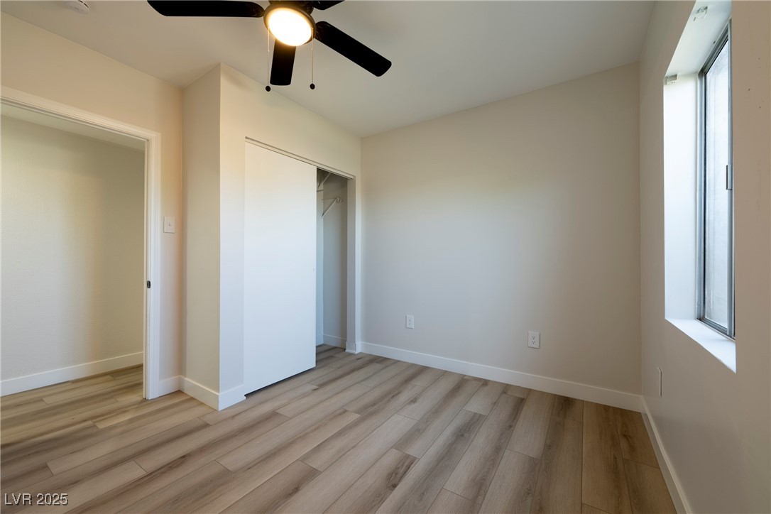 238 Kansas Avenue Henderson, NV 89015 - Photo 18 of 61 Unfurnished bedroom featuring light wood-style flooring, a ceiling fan, and a closet