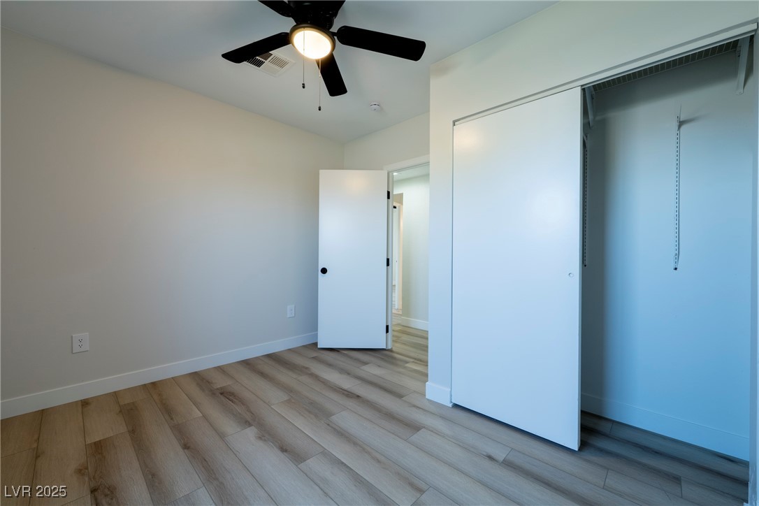 238 Kansas Avenue Henderson, NV 89015 - Photo 19 of 61 Unfurnished bedroom featuring ceiling fan, wood finished floors, and a closet