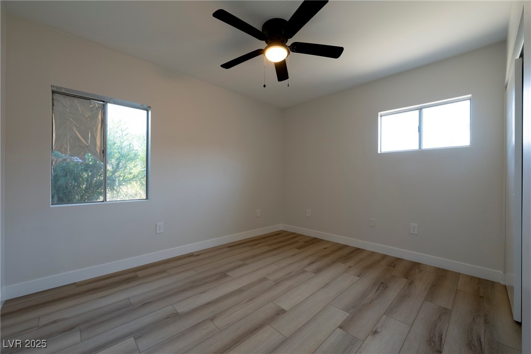 238 Kansas Avenue Henderson, NV 89015 - Photo 20 of 61 Spare room featuring light wood-type flooring, healthy amount of natural light, and a ceiling fan