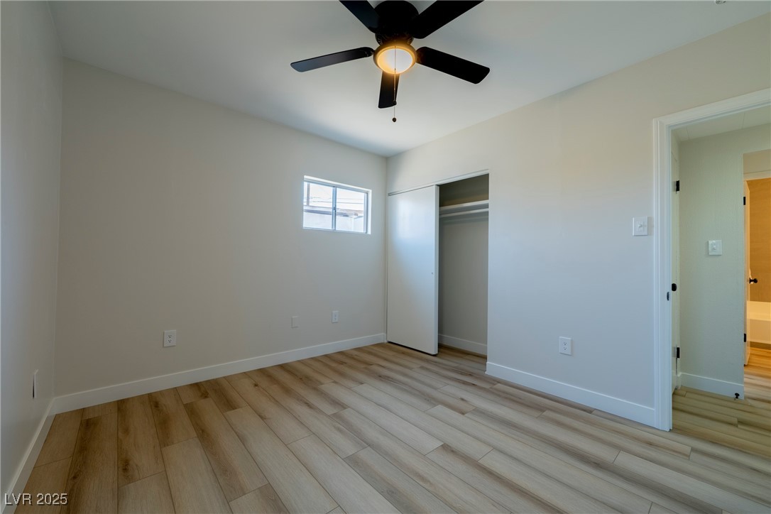 238 Kansas Avenue Henderson, NV 89015 - Photo 21 of 61 Unfurnished bedroom with ceiling fan, light wood finished floors, and a closet