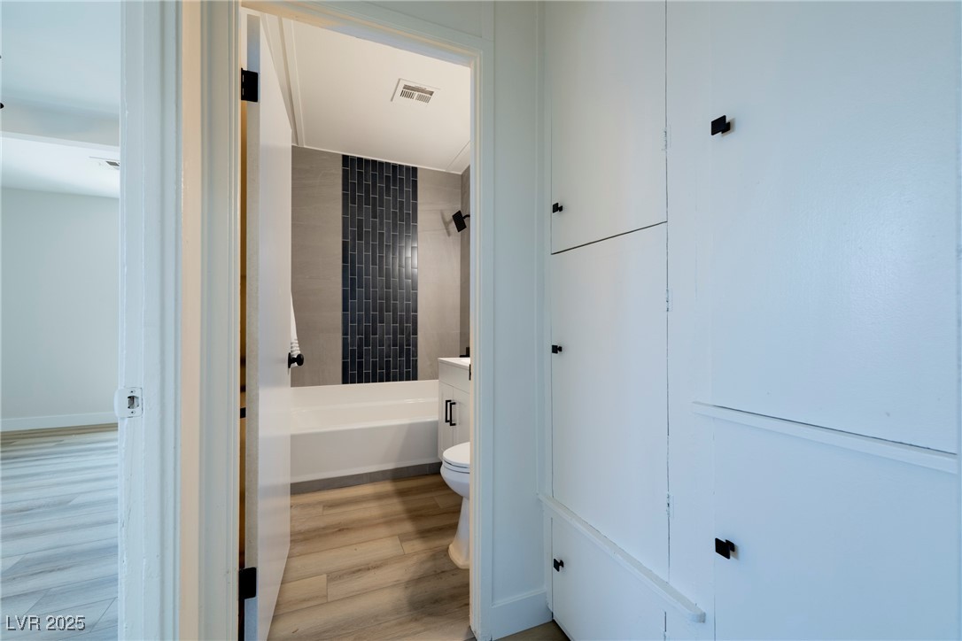 238 Kansas Avenue Henderson, NV 89015 - Photo 23 of 61 Bathroom with light wood-type flooring, shower / bathtub combination, and vanity