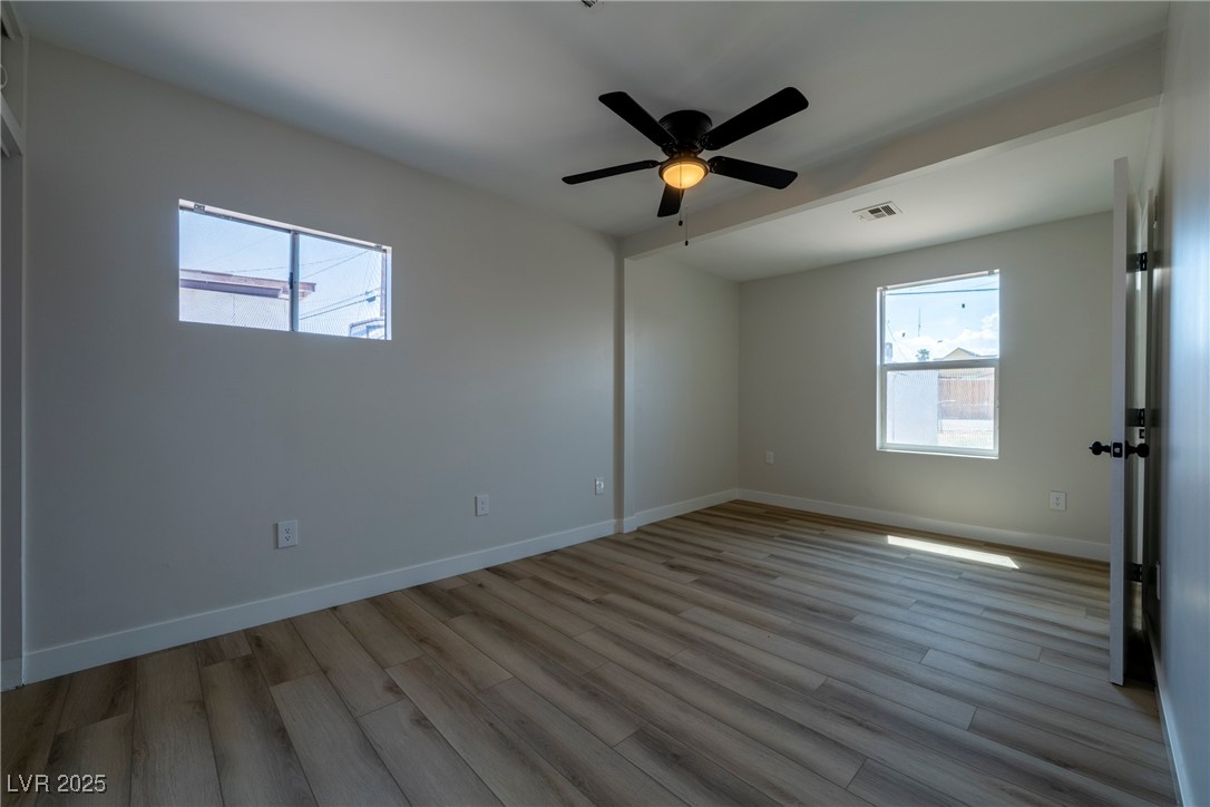 238 Kansas Avenue Henderson, NV 89015 - Photo 25 of 61 Unfurnished bedroom with light wood-style floors and ceiling fan