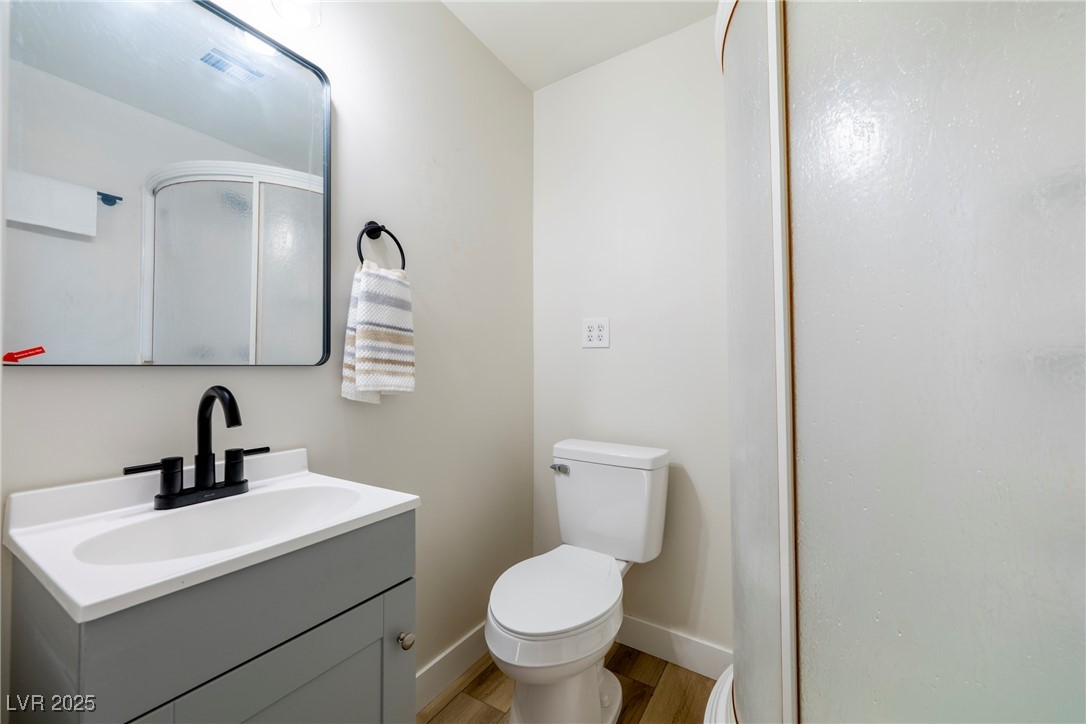 238 Kansas Avenue Henderson, NV 89015 - Photo 28 of 61 Full bath featuring a stall shower, vanity, and light wood-style flooring