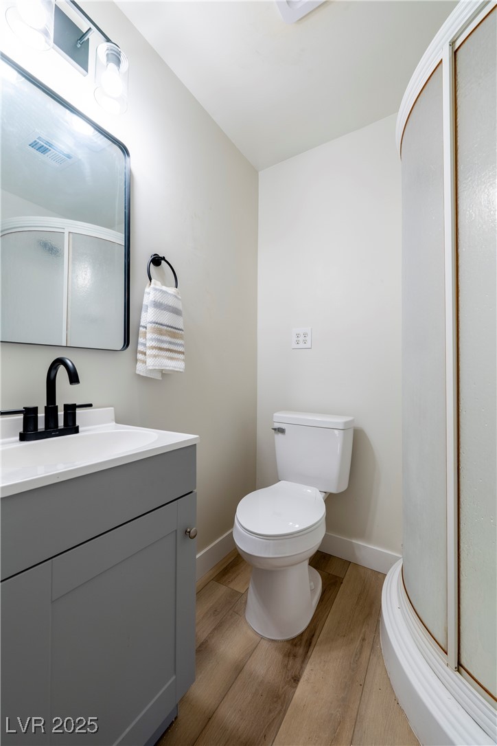238 Kansas Avenue Henderson, NV 89015 - Photo 29 of 61 Bathroom featuring a stall shower, light wood-style floors, and vanity