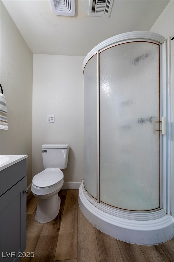 238 Kansas Avenue Henderson, NV 89015 - Photo 30 of 61 Full bath featuring wood finished floors, a shower stall, and vanity