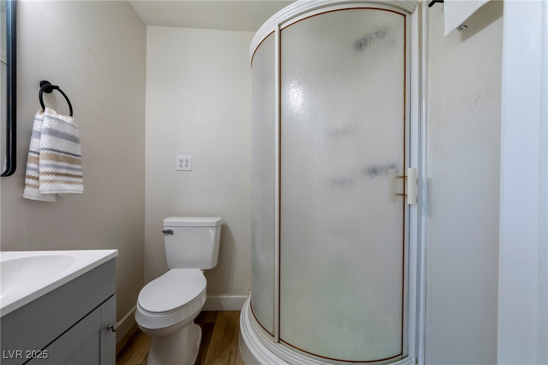 238 Kansas Avenue Henderson, NV 89015 - Photo 34 of 61 Full bathroom featuring a stall shower, vanity, and light wood finished floors