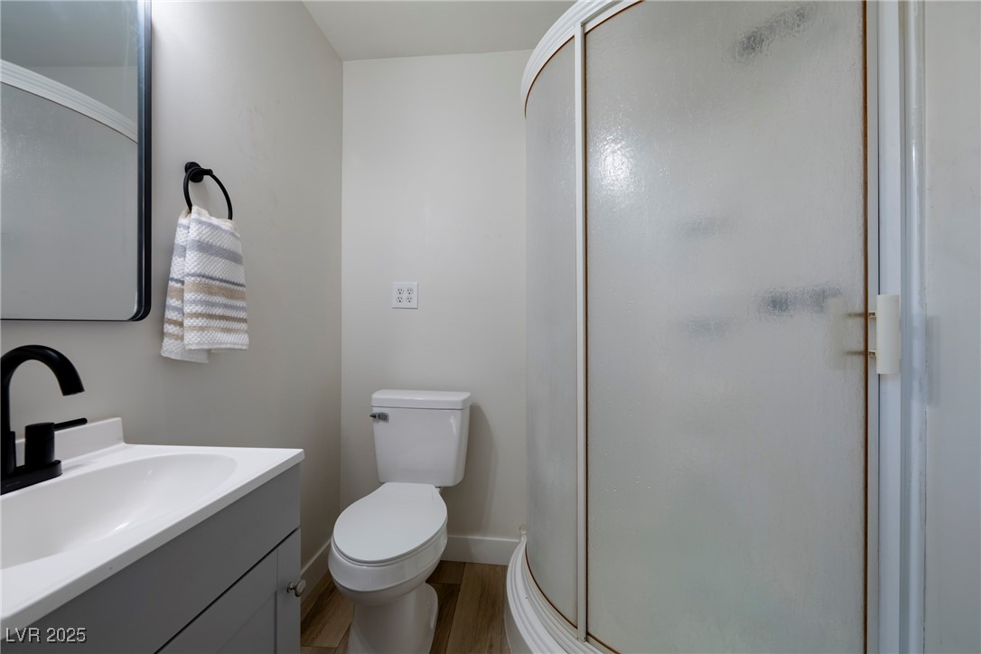238 Kansas Avenue Henderson, NV 89015 - Photo 35 of 61 Full bath featuring vanity, a shower stall, and light wood-style flooring