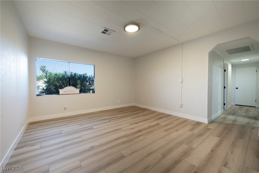 238 Kansas Avenue Henderson, NV 89015 - Photo 4 of 61 Spare room featuring light wood-type flooring and arched walkways