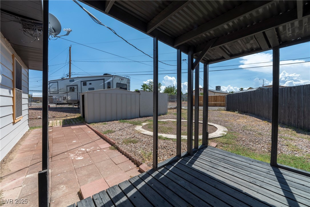 238 Kansas Avenue Henderson, NV 89015 - Photo 41 of 61 Fenced backyard featuring a shed, a patio, and a wooden deck