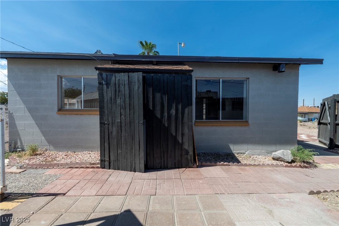 238 Kansas Avenue Henderson, NV 89015 - Photo 45 of 61 Rear view of property featuring concrete block siding and a patio