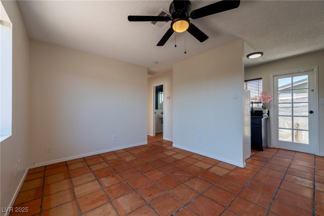 238 Kansas Avenue Henderson, NV 89015 - Photo 48 of 61 Empty room with a textured ceiling, ceiling fan, and tile patterned floors