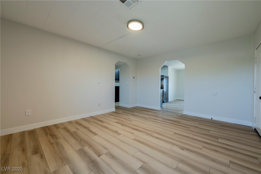 238 Kansas Avenue Henderson, NV 89015 - Photo 5 of 61 Unfurnished room with arched walkways and light wood-style floors