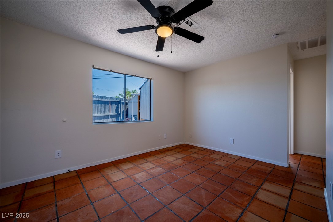 238 Kansas Avenue Henderson, NV 89015 - Photo 52 of 61 Tiled spare room featuring a textured ceiling and a ceiling fan