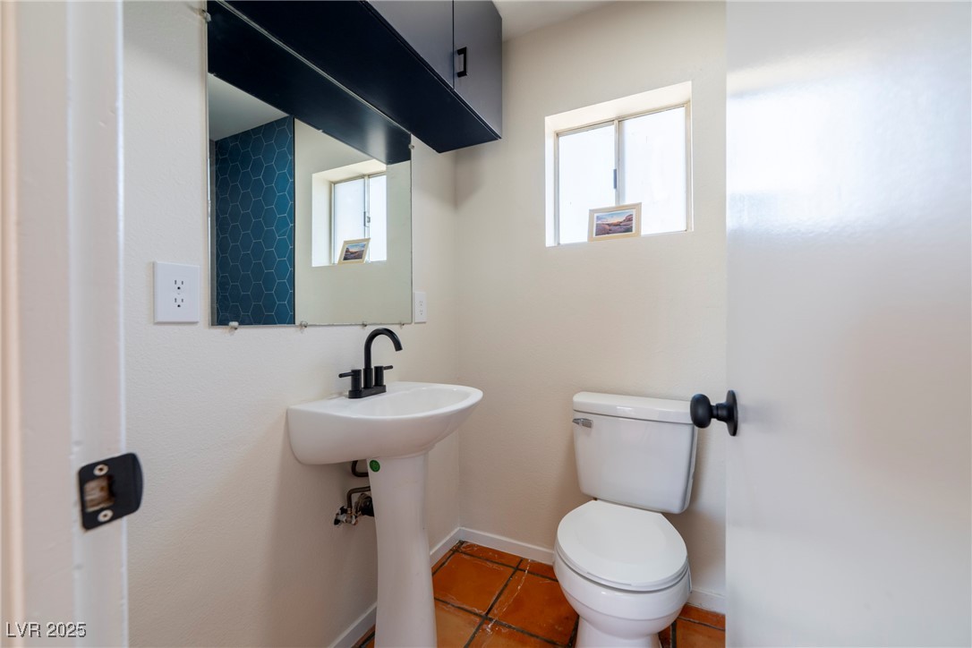 238 Kansas Avenue Henderson, NV 89015 - Photo 53 of 61 Half bathroom with toilet and light tile patterned flooring