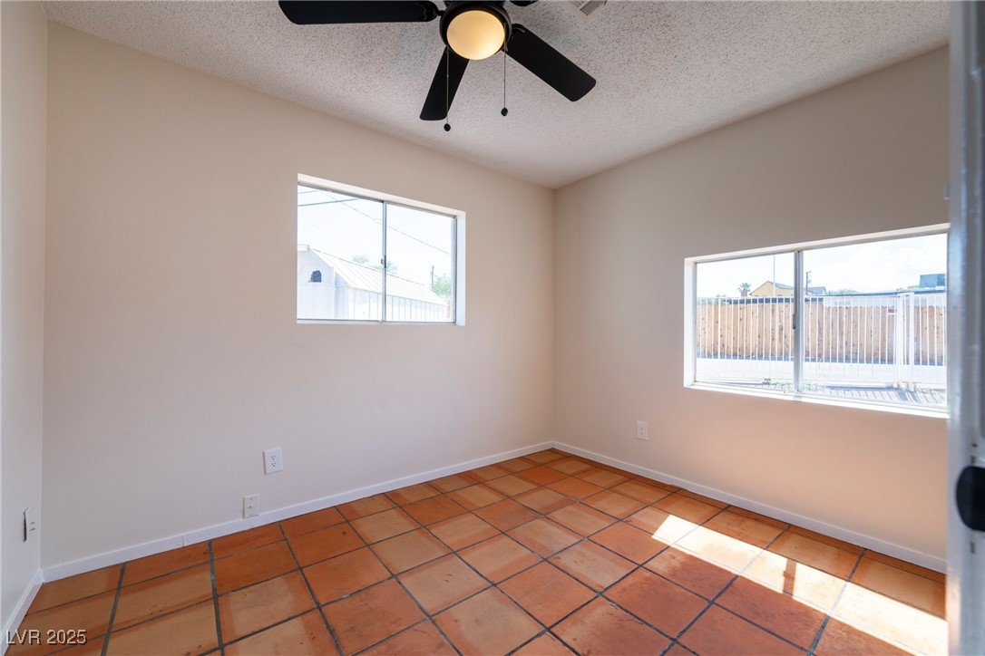 238 Kansas Avenue Henderson, NV 89015 - Photo 55 of 61 Spare room with a textured ceiling, tile patterned floors, and ceiling fan