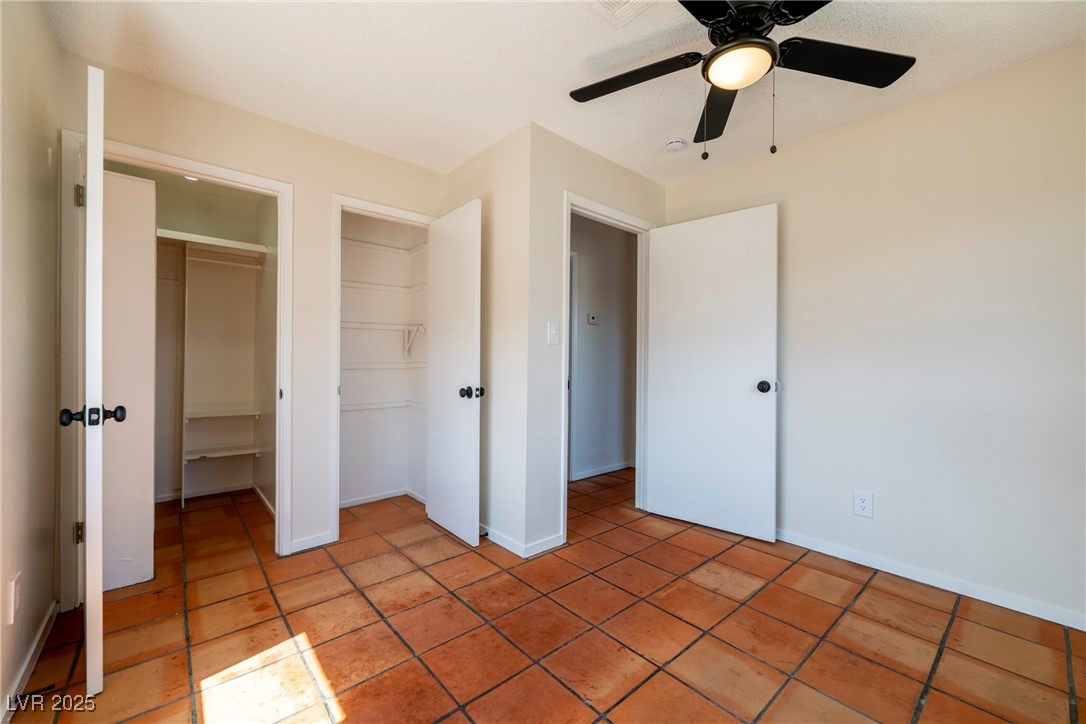 238 Kansas Avenue Henderson, NV 89015 - Photo 57 of 61 Unfurnished bedroom with ceiling fan, light tile patterned floors, and a spacious closet