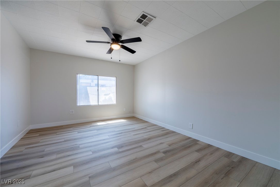 238 Kansas Avenue Henderson, NV 89015 - Photo 7 of 61 Spare room featuring light wood-style flooring and a ceiling fan