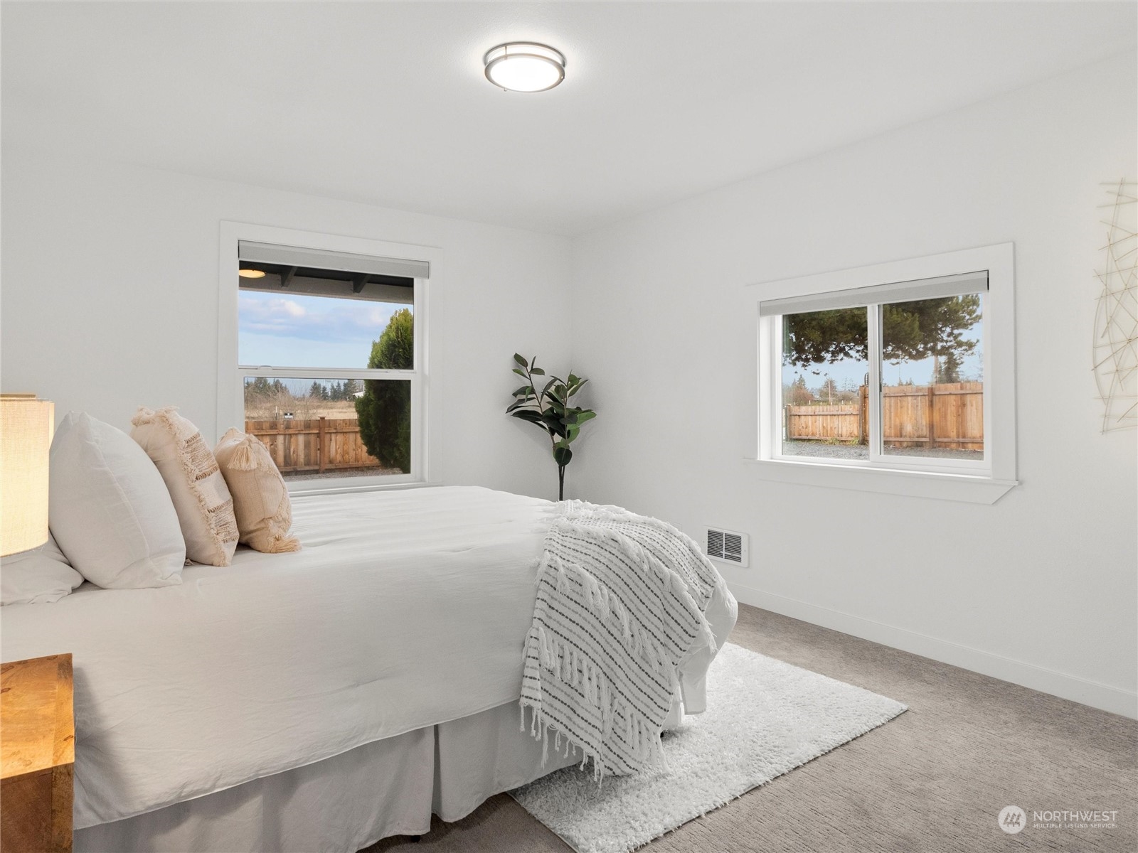 9331 Cullens Road Southeast Yelm, WA 98597 - Photo 11 of 28 a bedroom with a bed and a painting on the wall