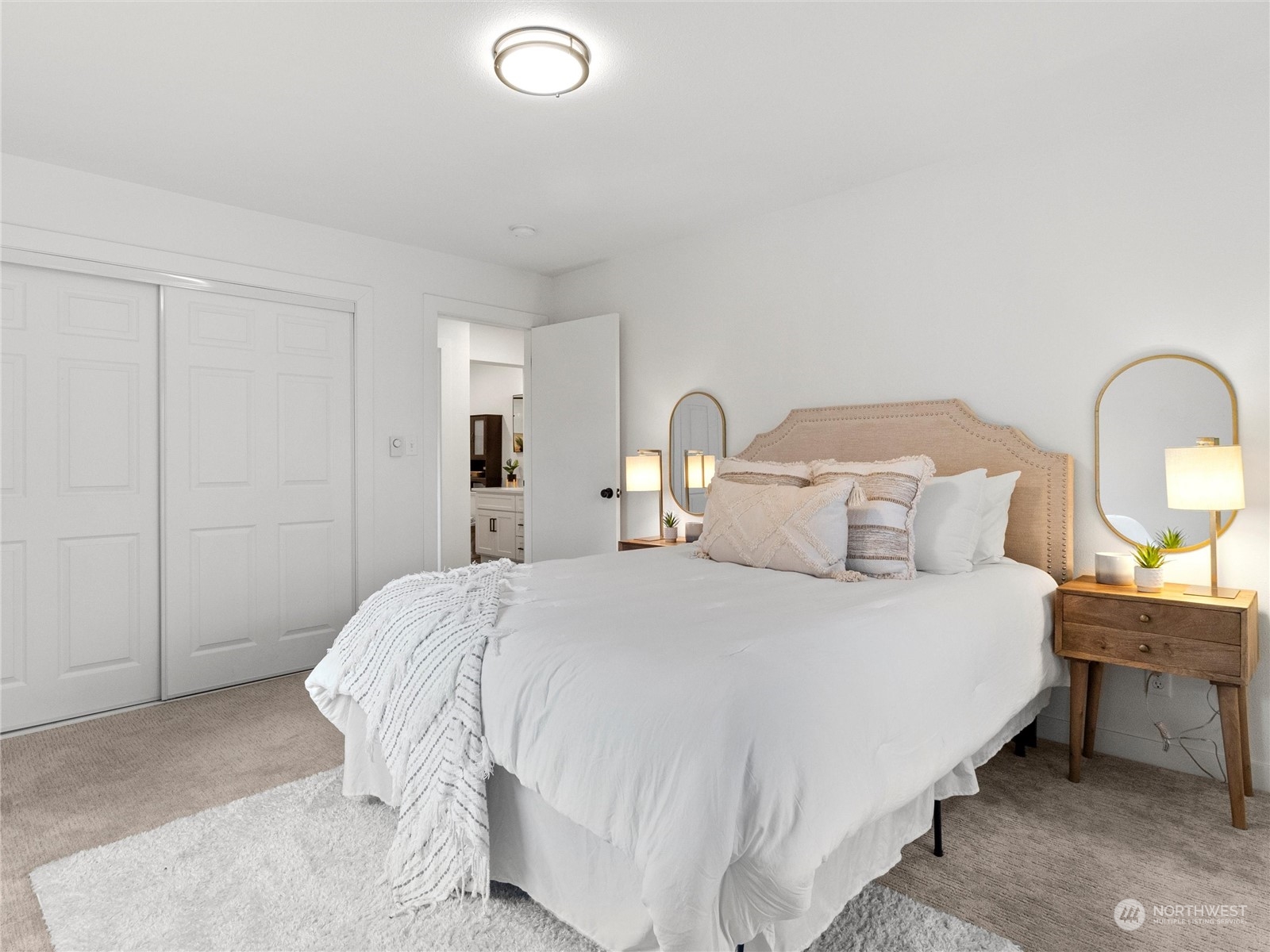 9331 Cullens Road Southeast Yelm, WA 98597 - Photo 12 of 28 a bedroom with a bed and a potted plant on dresser