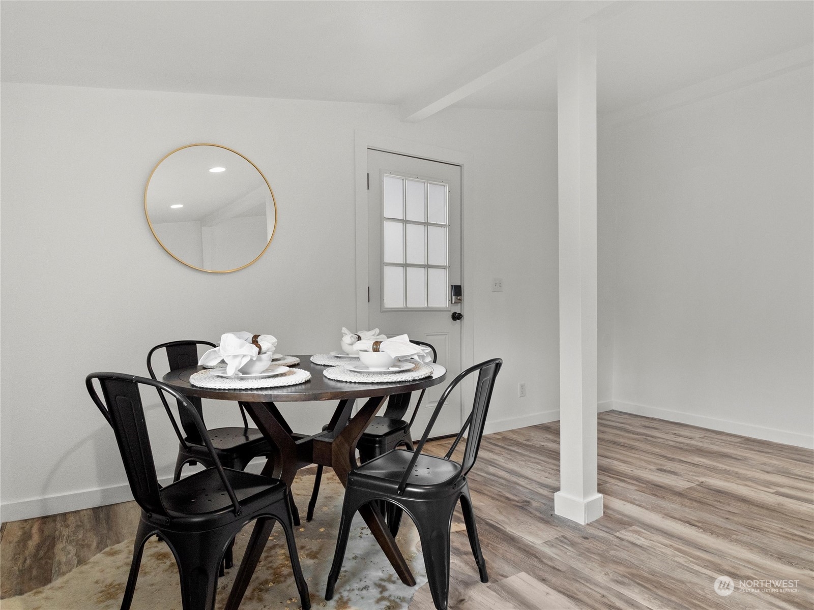 9331 Cullens Road Southeast Yelm, WA 98597 - Photo 18 of 28 a view of a dining room with furniture and wooden floor