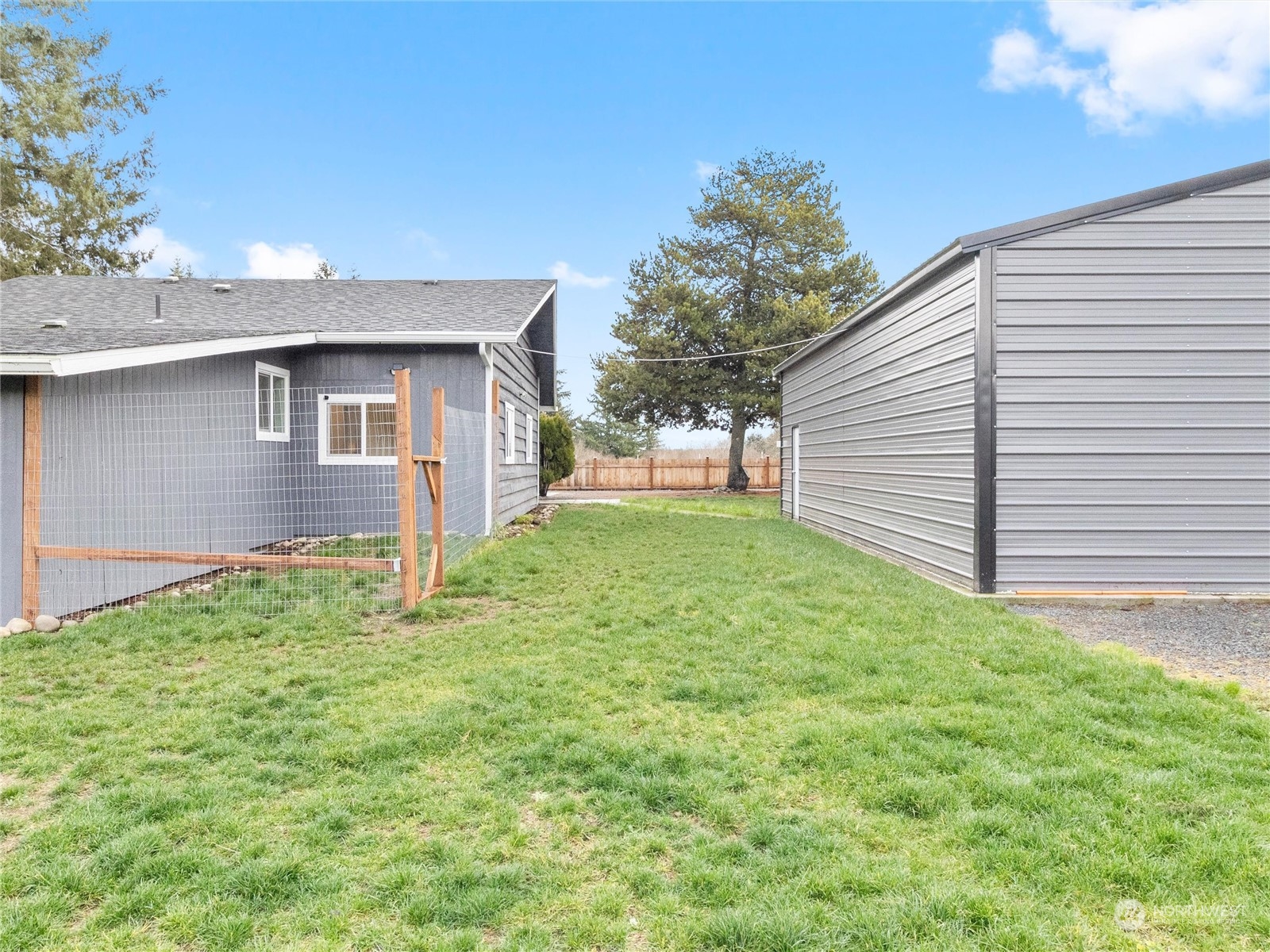 9331 Cullens Road Southeast Yelm, WA 98597 - Photo 24 of 28 a backyard of a house with table and chairs